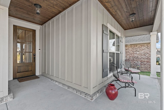 entrance to property featuring board and batten siding and covered porch