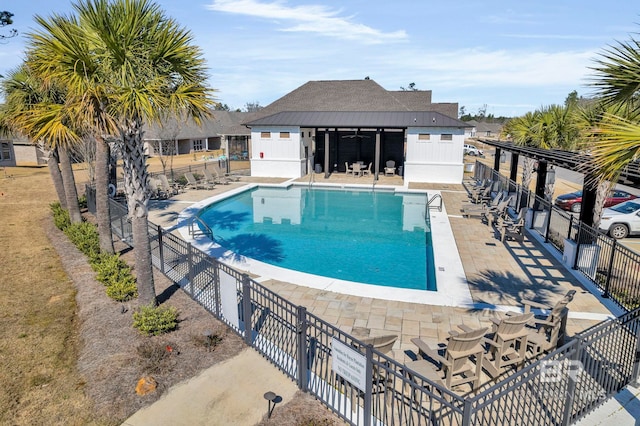 pool featuring a patio area and fence