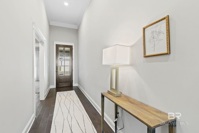 entryway with dark wood finished floors, baseboards, and ornamental molding