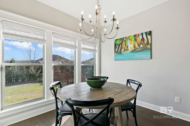 dining room featuring baseboards, dark wood-style flooring, and a chandelier