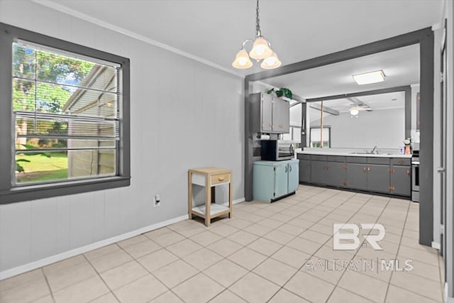 4918 Quimby Dr, Mobile, AL 36619 - unfurnished dining area with ornamental molding, light tile patterned flooring, baseboards, a sink, and a chandelier