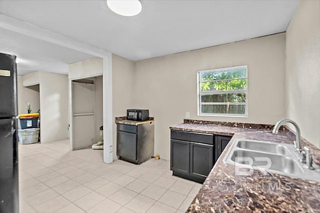 4918 Quimby Dr, Mobile, AL 36619 - kitchen with a sink, light tile patterned floors, and fridge