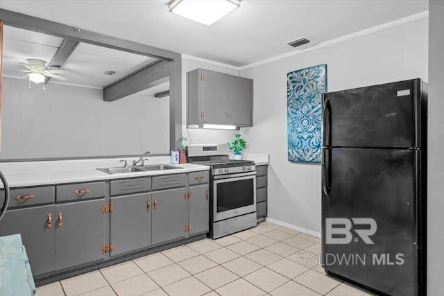 4918 Quimby Dr, Mobile, AL 36619 - kitchen with freestanding refrigerator, stainless steel range with gas cooktop, a sink, gray cabinetry, and ornamental molding