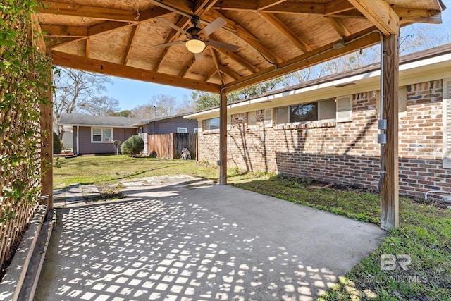 view of patio with ceiling fan and fence