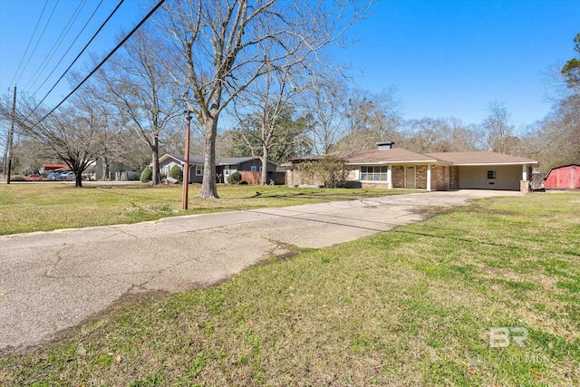 view of front of property with concrete driveway and a front lawn