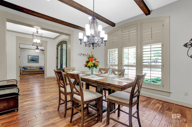 917 Rockaway Creek Rd, Atmore, AL 36502 - dining space with beamed ceiling, an inviting chandelier, baseboards, arched walkways, and wood finished floors