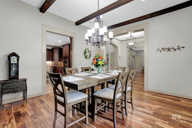 917 Rockaway Creek Rd, Atmore, AL 36502 - dining room with arched walkways, an inviting chandelier, beamed ceiling, light wood finished floors, and baseboards