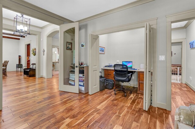 917 Rockaway Creek Rd, Atmore, AL 36502 - office featuring crown molding, a chandelier, baseboards, arched walkways, and light wood finished floors