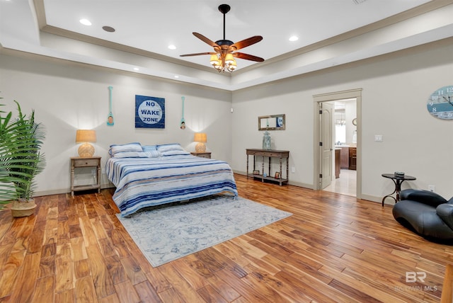 917 Rockaway Creek Rd, Atmore, AL 36502 - bedroom featuring light wood-style flooring, recessed lighting, and a tray ceiling