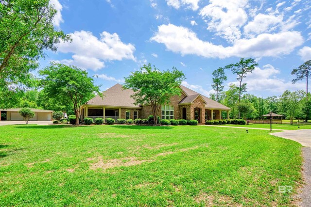 917 Rockaway Creek Rd, Atmore, AL 36502 - rear view of house featuring a lawn, a shingled roof, and brick siding