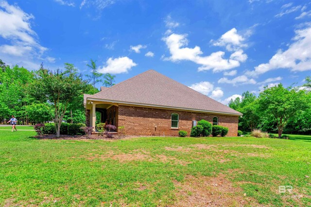 917 Rockaway Creek Rd, Atmore, AL 36502 - view of side of home with a lawn, roof with shingles, and brick siding