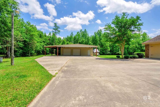 917 Rockaway Creek Rd, Atmore, AL 36502 - view of front facade with a detached garage, brick siding, an outdoor structure, and a front lawn
