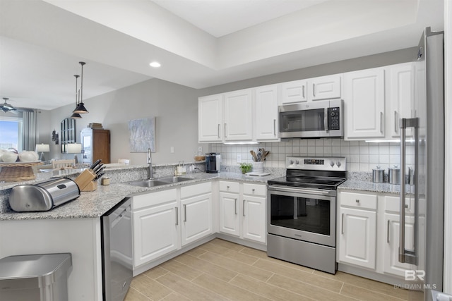 kitchen with white cabinetry, sink, backsplash, and appliances with stainless steel finishes