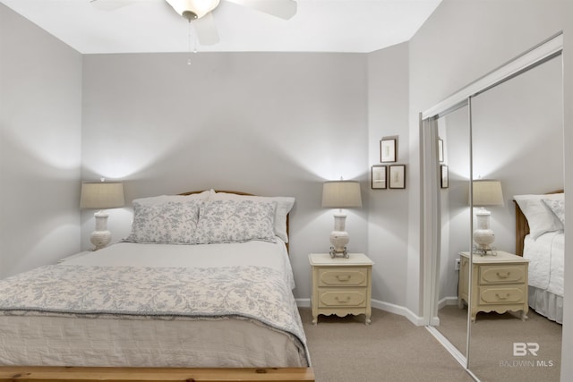 carpeted bedroom featuring ceiling fan and a closet