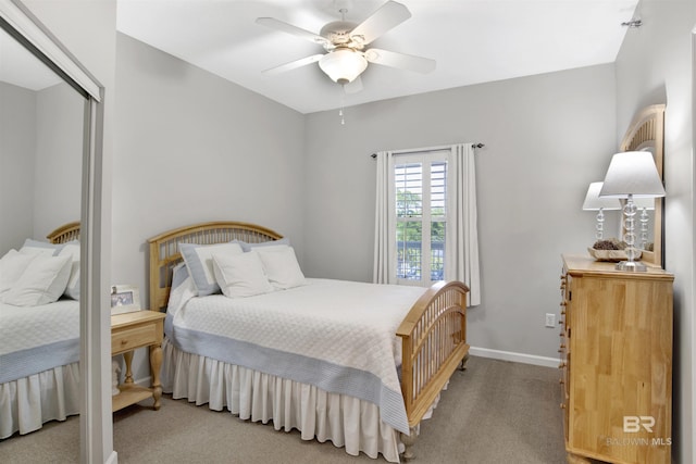 carpeted bedroom featuring ceiling fan and a closet