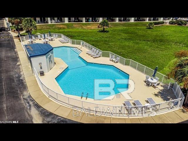 view of swimming pool with a yard and a patio