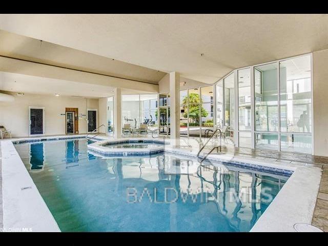 view of swimming pool with an indoor hot tub