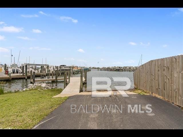 exterior space featuring a water view and a boat dock