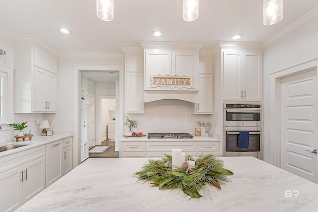 kitchen with white cabinets, decorative light fixtures, and stainless steel appliances