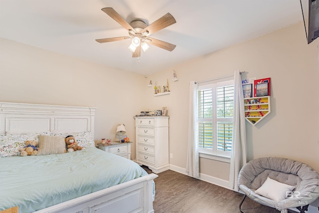 bedroom with dark hardwood / wood-style flooring and ceiling fan