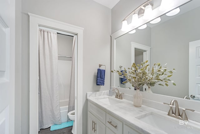 full bathroom with vanity, toilet, and shower / tub combo with curtain