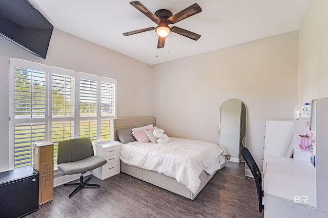 bedroom with dark hardwood / wood-style floors and ceiling fan