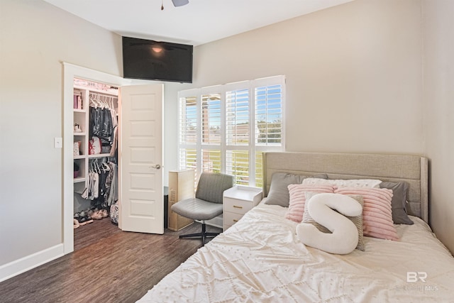 bedroom with dark hardwood / wood-style flooring and a closet