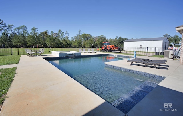 view of pool with an in ground hot tub, a patio, and a lawn