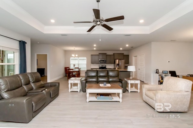 12927 Sanderling Loop, Spanish Fort, AL 36527 - living room featuring a raised ceiling, healthy amount of natural light, a ceiling fan, recessed lighting, and ornamental molding