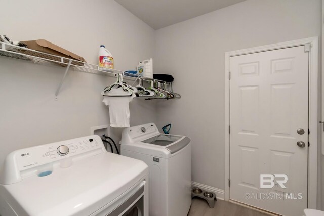 12927 Sanderling Loop, Spanish Fort, AL 36527 - laundry room with washer and dryer and light wood-style flooring