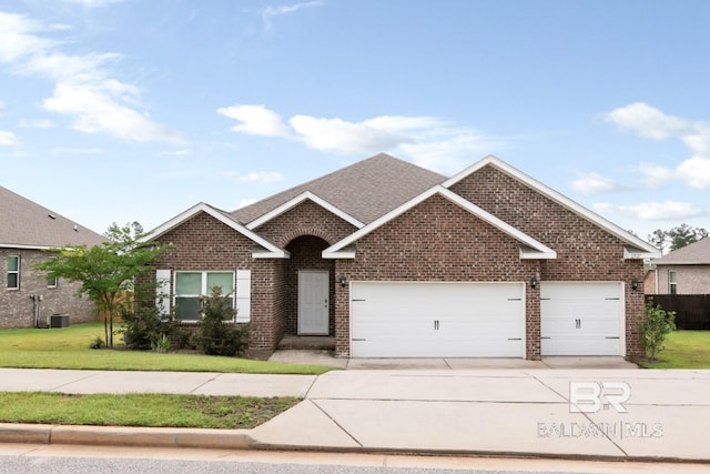12927 Sanderling Loop, Spanish Fort, AL 36527 - view of front of property with brick siding, an attached garage, concrete driveway, a front yard, and roof with shingles