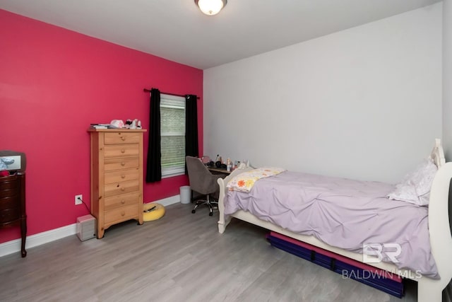 12927 Sanderling Loop, Spanish Fort, AL 36527 - bedroom featuring wood finished floors and an accent wall
