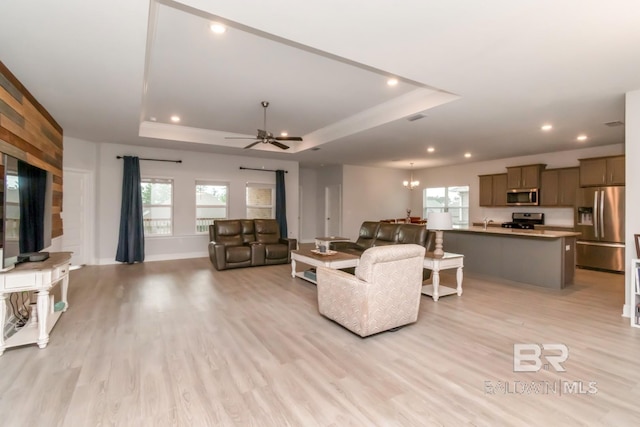 12927 Sanderling Loop, Spanish Fort, AL 36527 - living room featuring a tray ceiling, light wood finished floors, a ceiling fan, and recessed lighting