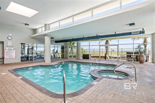 26750 Perdido Beach Blvd Unit 708, Orange Beach, AL 36561 - view of swimming pool featuring a pool with connected hot tub and a skylight