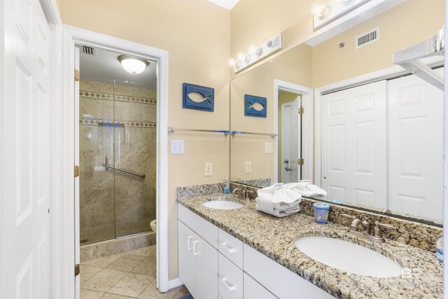 26750 Perdido Beach Blvd Unit 708, Orange Beach, AL 36561 - full bathroom featuring double vanity, a shower stall, and tile patterned floors
