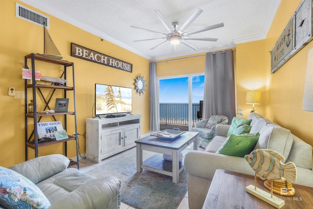 26750 Perdido Beach Blvd Unit 708, Orange Beach, AL 36561 - living room featuring ceiling fan, ornamental molding, a textured ceiling, and tile patterned flooring
