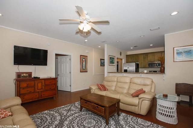 living room with ornamental molding, ceiling fan, and dark wood-type flooring