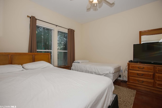 bedroom featuring ceiling fan and dark hardwood / wood-style floors