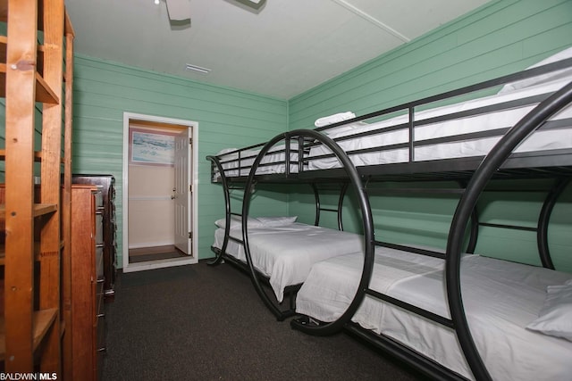 bedroom featuring dark carpet and ceiling fan