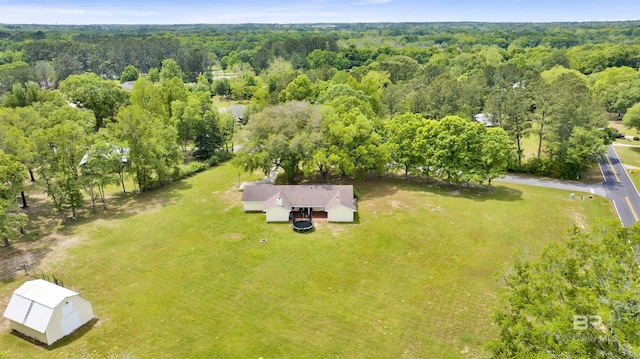 drone / aerial view with a wooded view