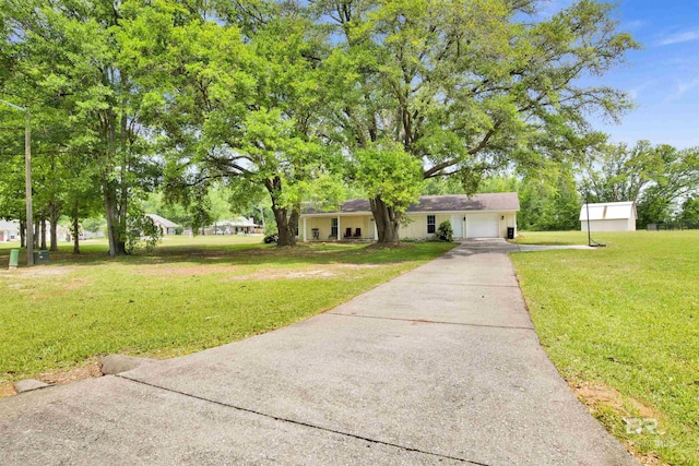 ranch-style home featuring an attached garage, a front lawn, and concrete driveway