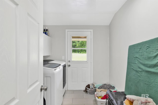 laundry area with washer and dryer and light tile patterned flooring