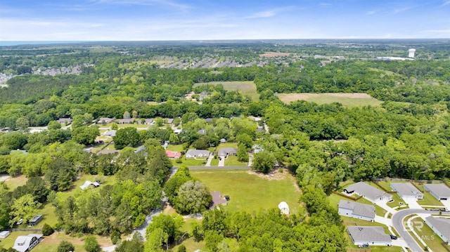 birds eye view of property with a wooded view and a residential view