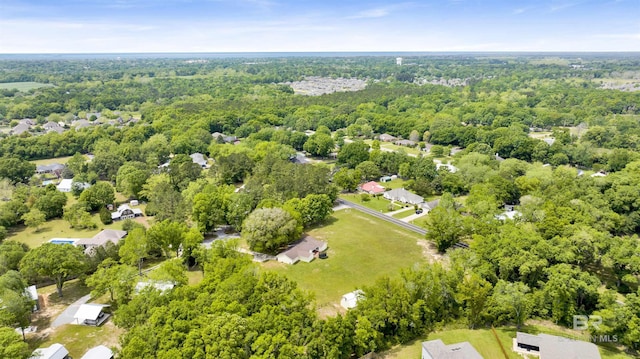 drone / aerial view with a wooded view