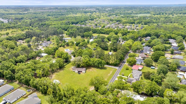 aerial view featuring a forest view and a residential view