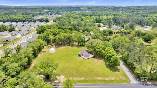 drone / aerial view with a forest view and a residential view