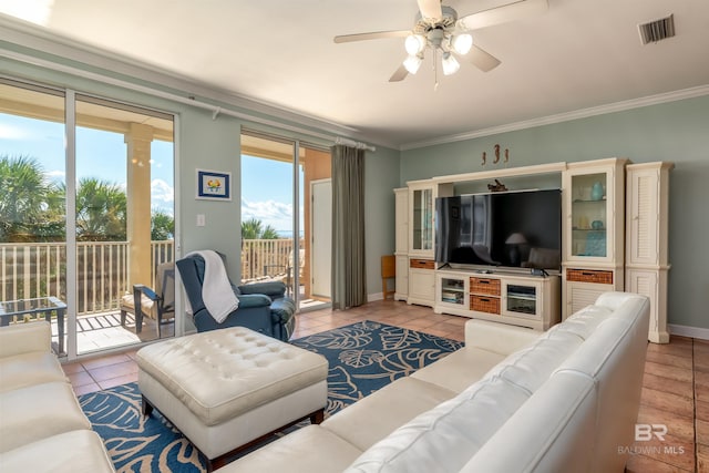 living room featuring ceiling fan, light tile flooring, and crown molding