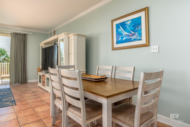 tiled dining area featuring crown molding