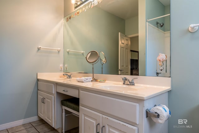 bathroom featuring double vanity and tile flooring