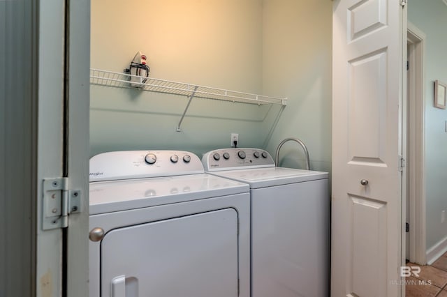 washroom with tile floors and washer and clothes dryer